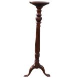 A mahogany jardinière stand with circular tray platform on fluted leaf carved column above