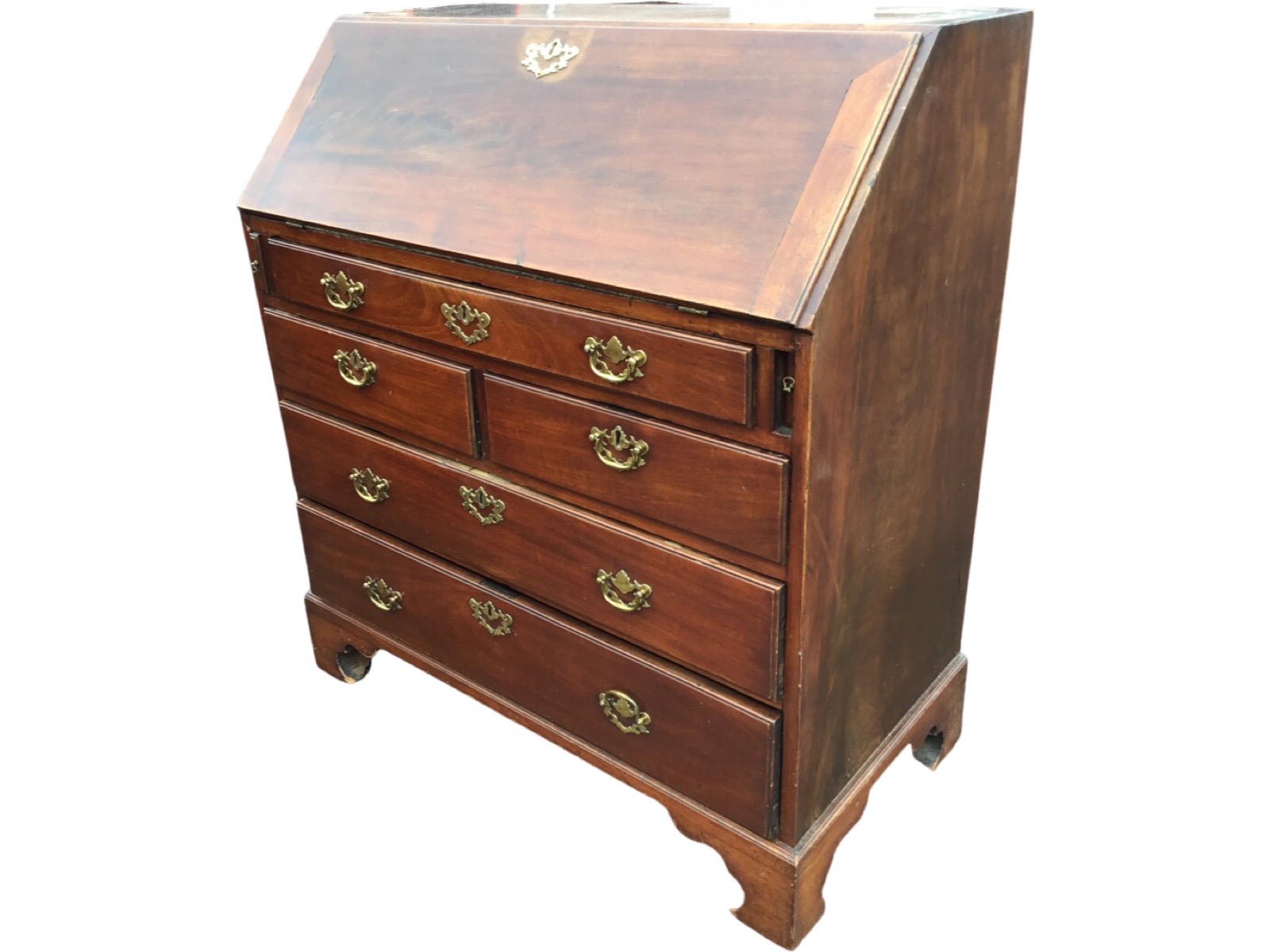 A George III mahogany bureau with cleated fallfront enclosing a fitted interior with drawers and