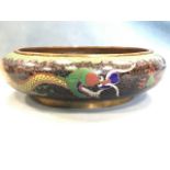 A bulbous cloisonné bowl having exterior with two dragons on black ground above waves beneath a