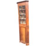 A slim Edwardian mahogany corner cabinet inlaid with boxwood stringing, with dentil cornice above