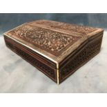 A late Victorian anglo-indian writing box, with two hinged covers carved with animal and birds