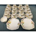 A Roslyn China twelve-piece teaset decorated in the Marigold pattern, enamelled with yellow & purple