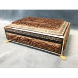 A late Victorian carved Anglo Indian casket decorated with panels of animals, birds and buildings