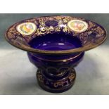 An overlaid cut glass bowl with flared rim and chamfered body raised on socle, overall decorated