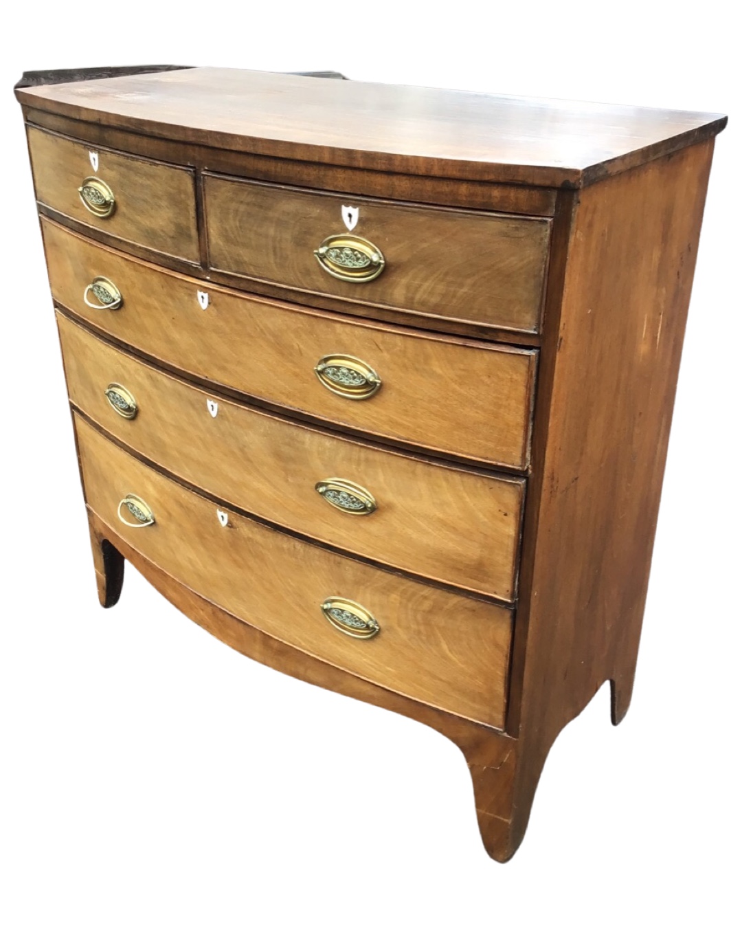 A Georgian mahogany bowfronted chest of drawers, the crossbanded top above two short and three