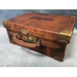 An Edwardian leather cartridge case with brass mounts by Watson Bros of Old Bond Street, the baize