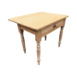 A Victorian pine kitchen table with drop-leaf to back, having knobbed frieze drawer, raised on