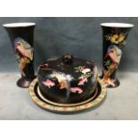 A pair of tapering Maling trumpet vases decorated with kingfishers on black ground with insects