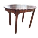 An oval mahogany coffee table with lozenge carved edge, raised on square moulded column legs with