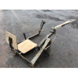 A WJ Bowman & Sons cast iron clay pigeon trap with wood seat beside aluminium sprung adjustable