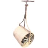 A weighted cast iron garden roller, the T-bar handle with scrolled supports, the barrel with