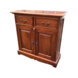 A mahogany cabinet with rectangular moulded top above two panelled frieze drawers and fielded