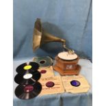 A wind-up gramophone with flared brass horn and diaphragm arm, the mechanical movement in