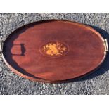 An oval nineteenth century mahogany tray with panel of inlaid decoration having scalloped gallery