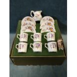 A cased Royal Crown Derby floral six-piece coffee set, and an associated cream jug in the Derby