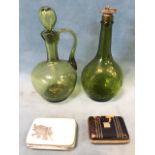 An olive glass twisted decanter jug & stopper, and a matching bottle with copper stopper dated 1763;