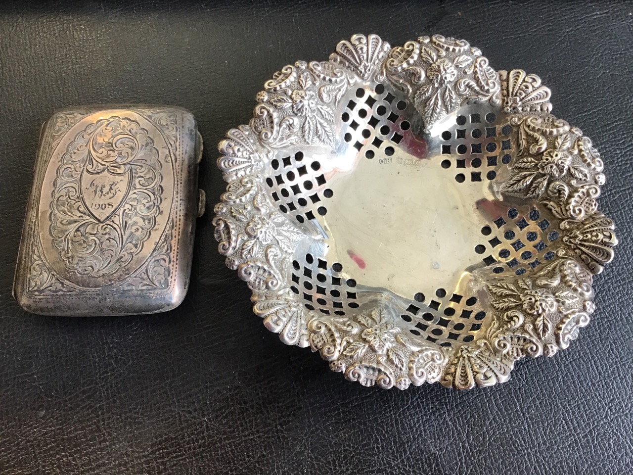 A Birmingham hallmarked scalloped silver bowl with pierced panels beneath embossed leaf scrolled