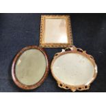 A rectangular gilt framed mirror with pierced scrolled border and beaded inner band; an oval plaster