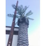 A large 15ft faux palm tree, the tapering noduled bark type column on metal plate stand, the top and