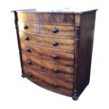 A nineteenth century bowfronted mahogany chest of drawers with plain frieze above two short and four