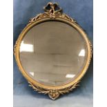 A circular nineteenth century mirror with bevelled plate in beaded gilt & gesso frame surmounted