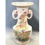 A nineteenth century Japanese vase, the waisted neck with elephant handles beneath flared rim,