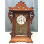 An American gingerbread mantle clock by Seth Thomas Clock Co, with pierced carved fretwork frame