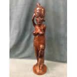 An African tribal art mahogany carving of a mother & child, mounted on circular plinth. (37in)