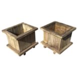 A pair of square wood garden tubs with plank sides and mesh bases, raised on battens. (21.75in x