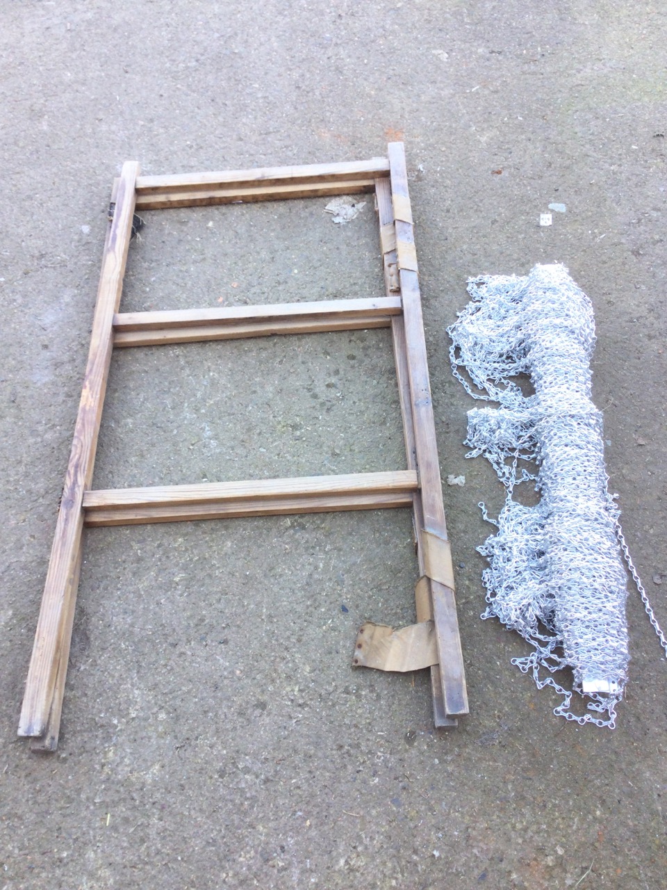 A pine twin-fold drying rack with six rails; and a Hug Flight chain mesh door curtain. (2)