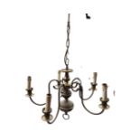 A Dutch style hanging brass light with five scrolled branches supporting candlelights around a