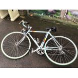 A classic Peugeot Ventoux lightweight road bike with drop handlebars, gel seat, Shimano brakes,