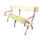 A Victorian garden bench with plank back and seat on three loggia cast iron supports with pad