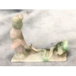A carved jade brush rest carved from one piece with figure standing with sword above a serpent/