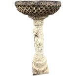 A composition stone garden birdbath with circular bowl on flower encrusted leaf moulded column,