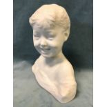 A parianware bust of a young boy, the happy child with drapes to shoulders - incised initials. (10.