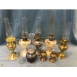 A collection of oil lamps - brass, Aladddin, a pair, Ingleton Pottery, all with glass chimneys, etc.