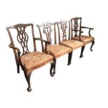 Four nineteenth century Chippendale style mahogany dining chairs, the pair of carvers with anthemion