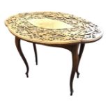 A nineteenth century oval scalloped top mahogany table carved with scrolled foliate blind fretwork