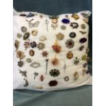 A cushion of costume jewellery brooches - cameos, bar brooches, filigree, polished stones, micro-
