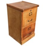 An oak two-drawer filing cabinet with brass label holders and handles. (15.75in x 17in x 28in)