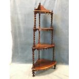 A Victorian rosewood corner whatnot with four graduated bowfronted shelves hung with scalloped