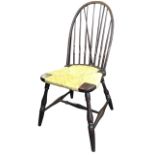 A rush seated windsor type chair with hooped back on finely turned spindles, the saddle shaped