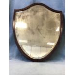 A large late Victorian shield shaped mahogany framed mirror with bevelled plate. (26in x 31.25in)