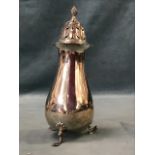 A hallmarked silver sugar castor of baluster form, the bell shaped pierced cover with twisted