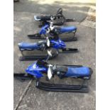 A set of three Yamaha ski bikes with padded seats and steering handlebars on sprung front glides;