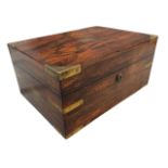 A Victorian rosewood box with brass military style mounts and handles, the interior with lidded