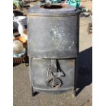 A large Jotul tapering log burning stove, the rounded burner with hammered type metal finish