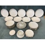 A German porcelain dinner service with silvered rims by Jonelle - bowls, side, dinner & dessert