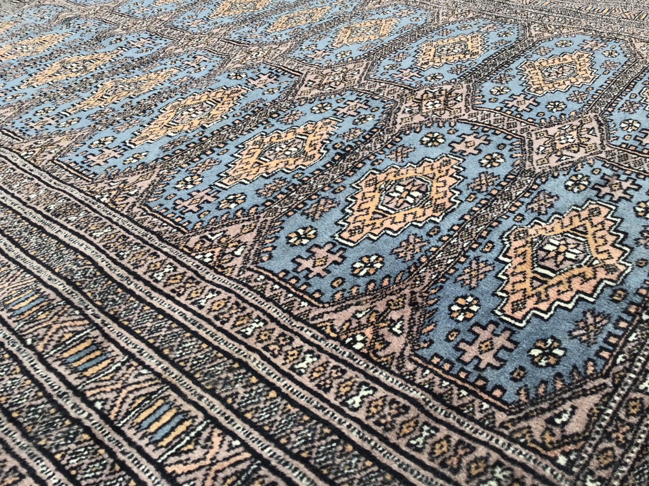 An eastern rug woven with field of sixteen blue panels on grey ground, framed by multiple - Image 3 of 3